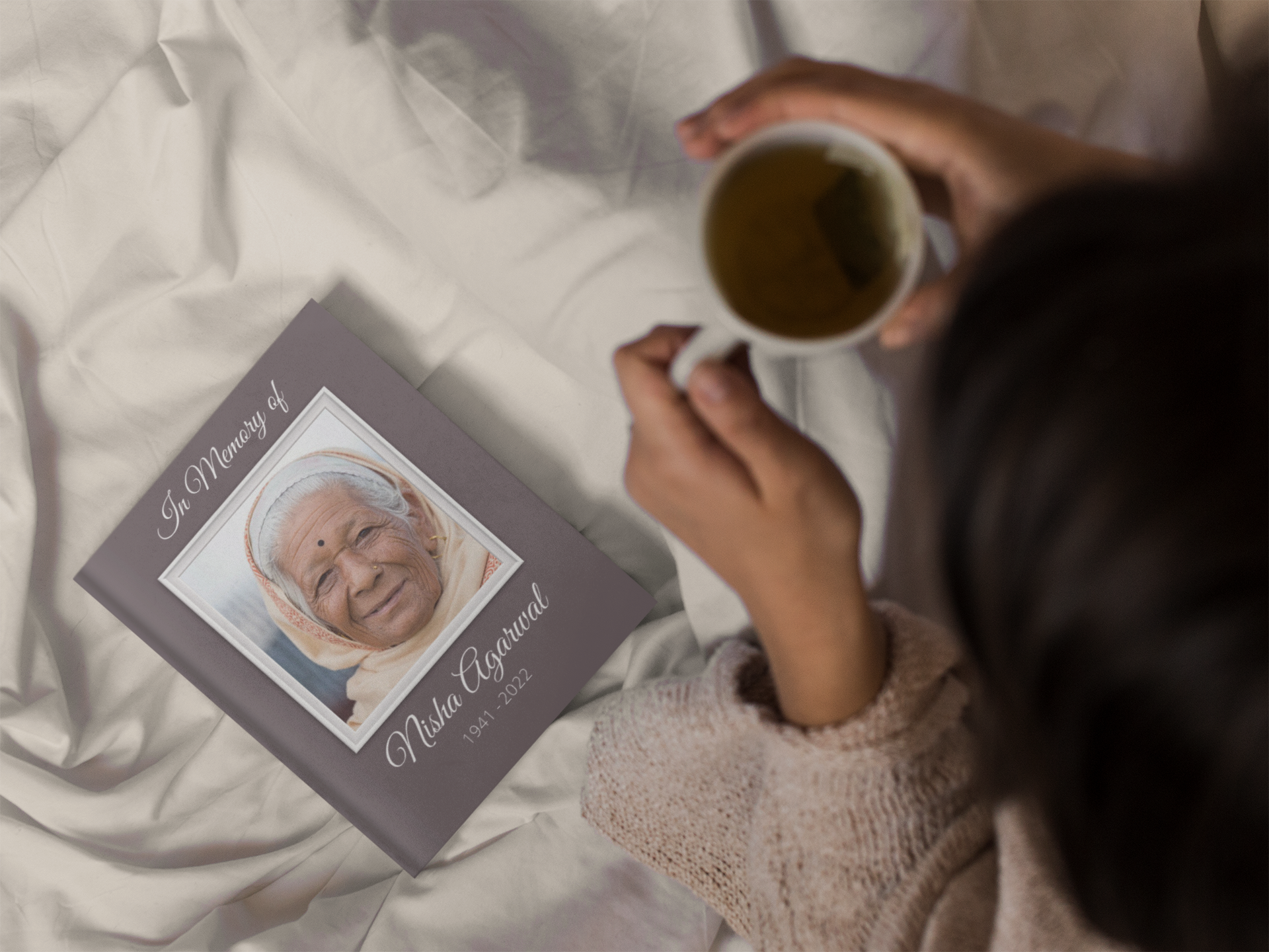 Offering a commemorative photo book as a gift to a grieving loved one